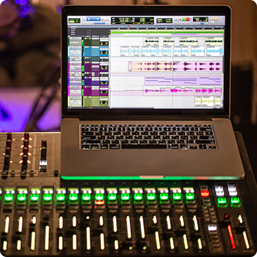 Laptop running audio software on top of a professional sound mixer at a trade show AV rental setup